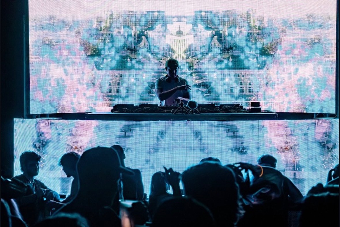 DJ NAD performing behind the decks before a live crowd